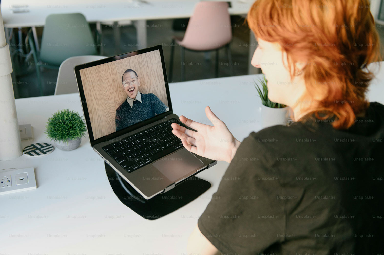 a woman sitting at a table with a laptop