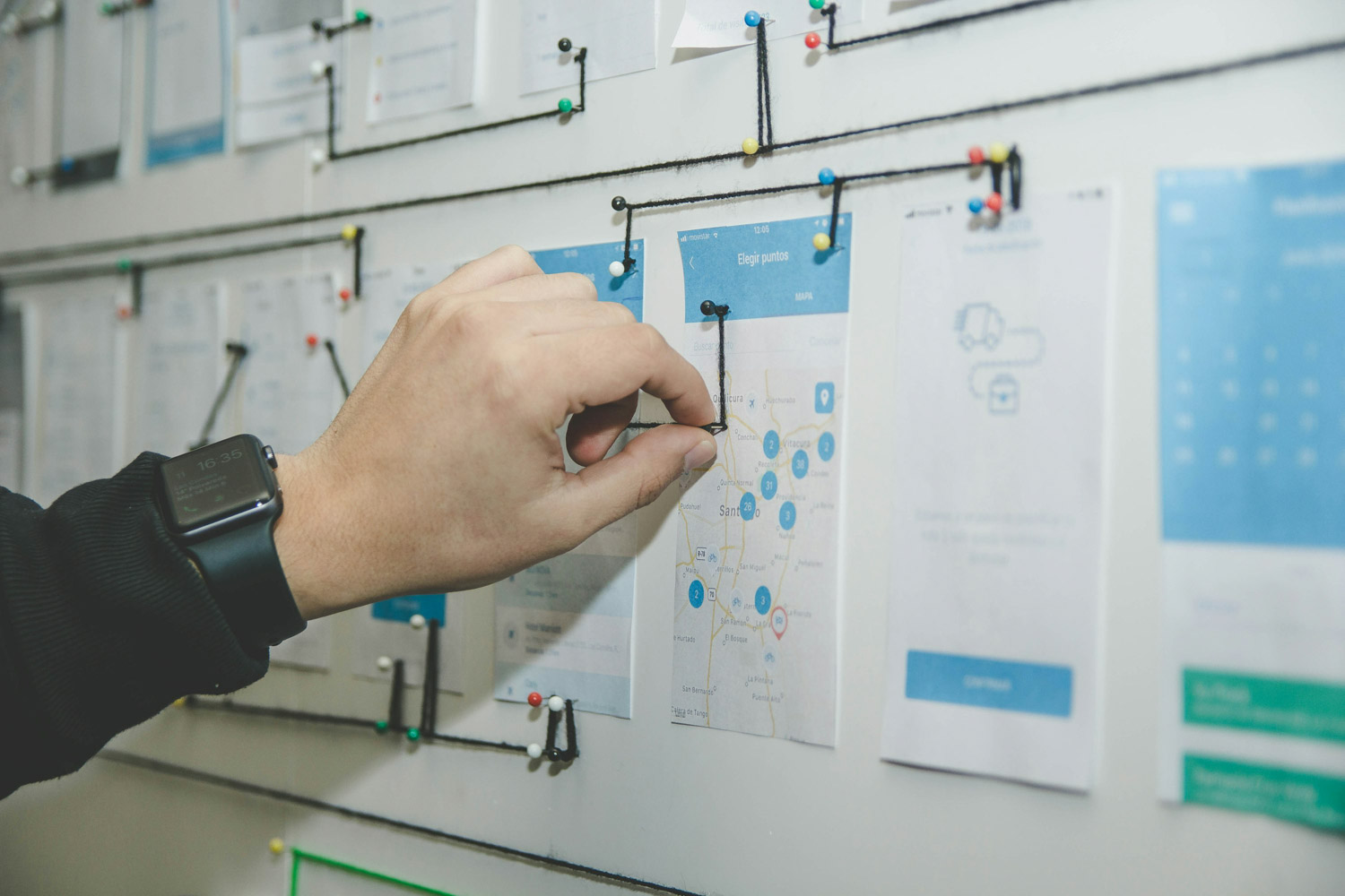 person working on blue and white paper on board, user testing